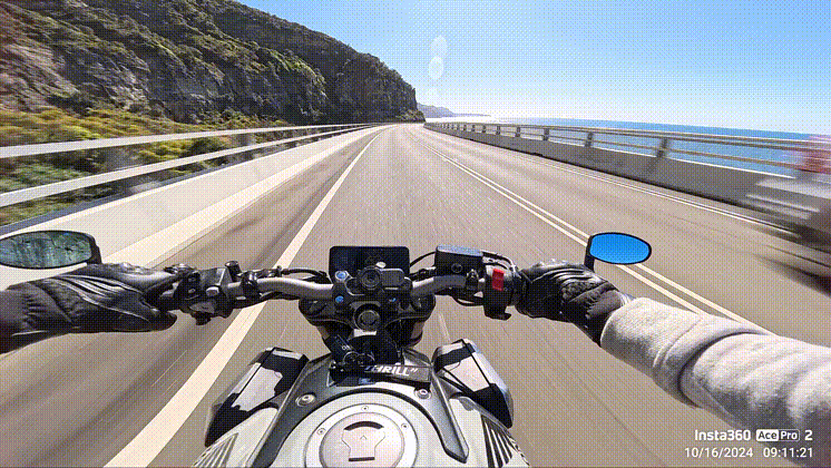 A motorcycle on a mountain lane shot from the perspective of the handlebars. The footage is being deleted as it's recorded showing Insta360 Ace Pro 2 can be used as a motorcycle dash cam.